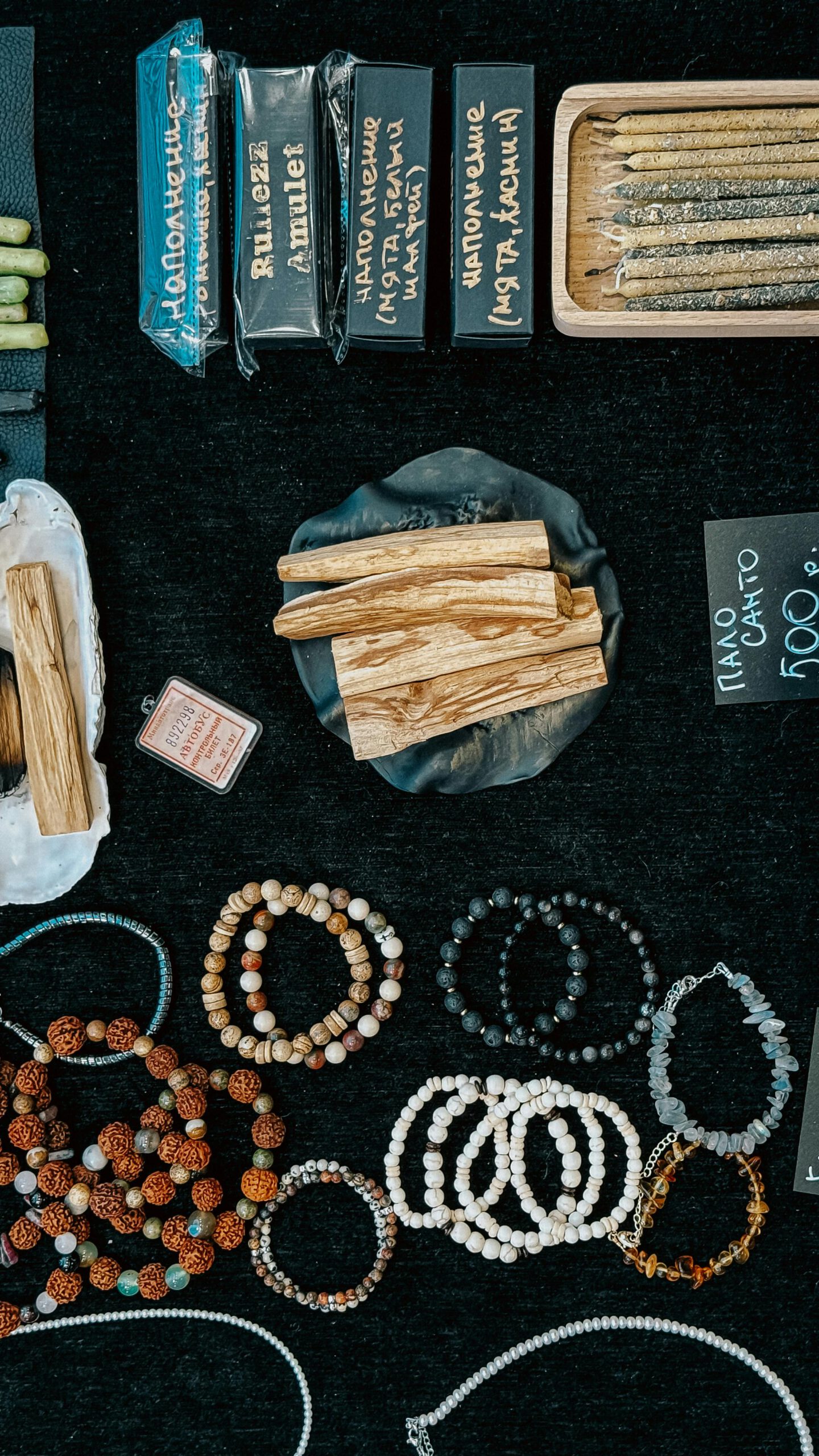Unique handcrafted bracelets and incense displayed on a market table, perfect for bohemian decor.